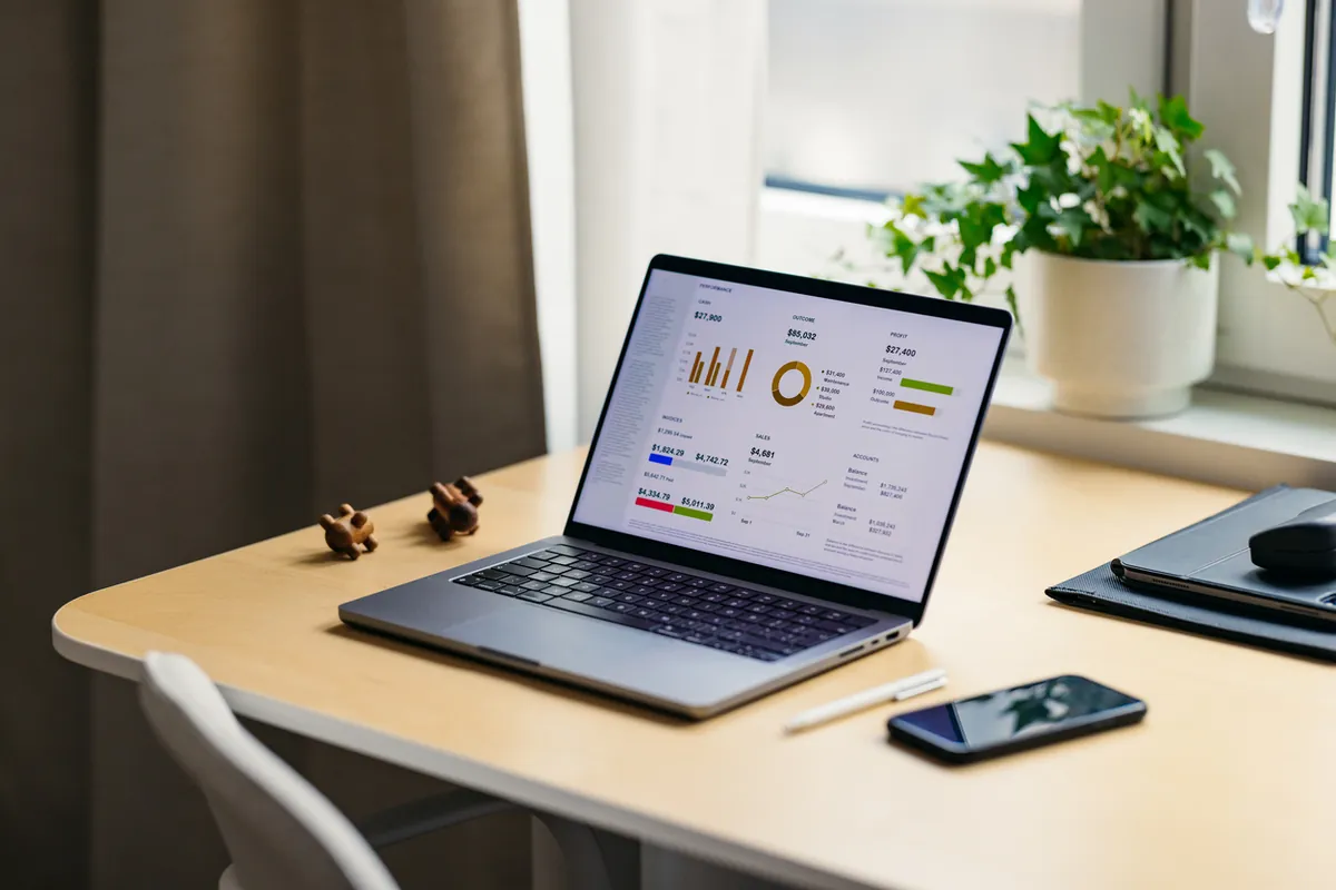 Laptop showing a business dashboard on a home office desk