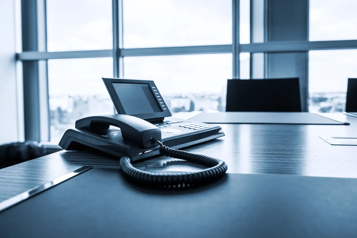 IP desk phone on a boardroom table in a modern office